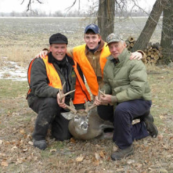 Deer hunters holding antlers